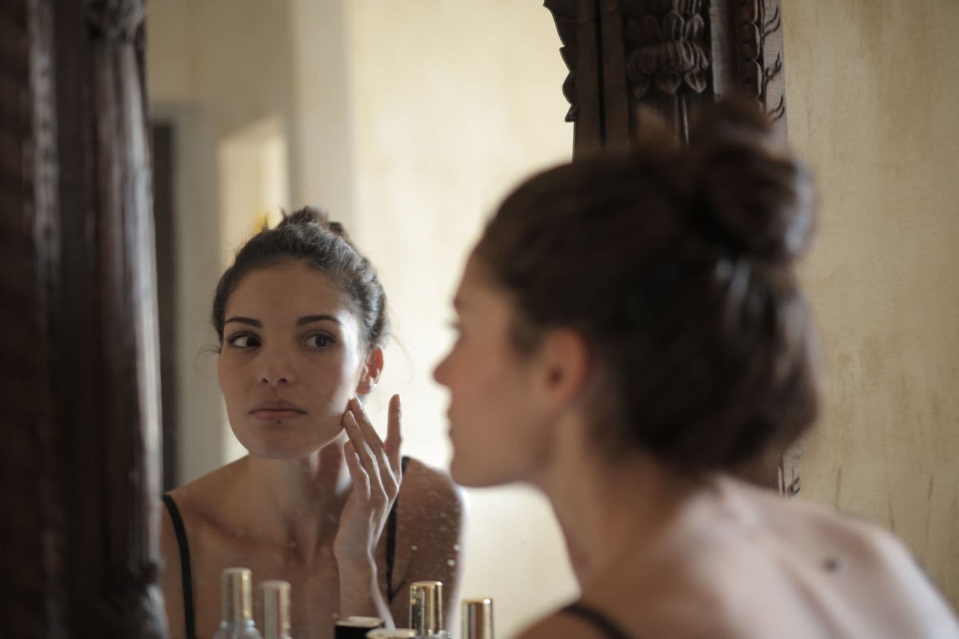 A person checking their skin in a mirror
