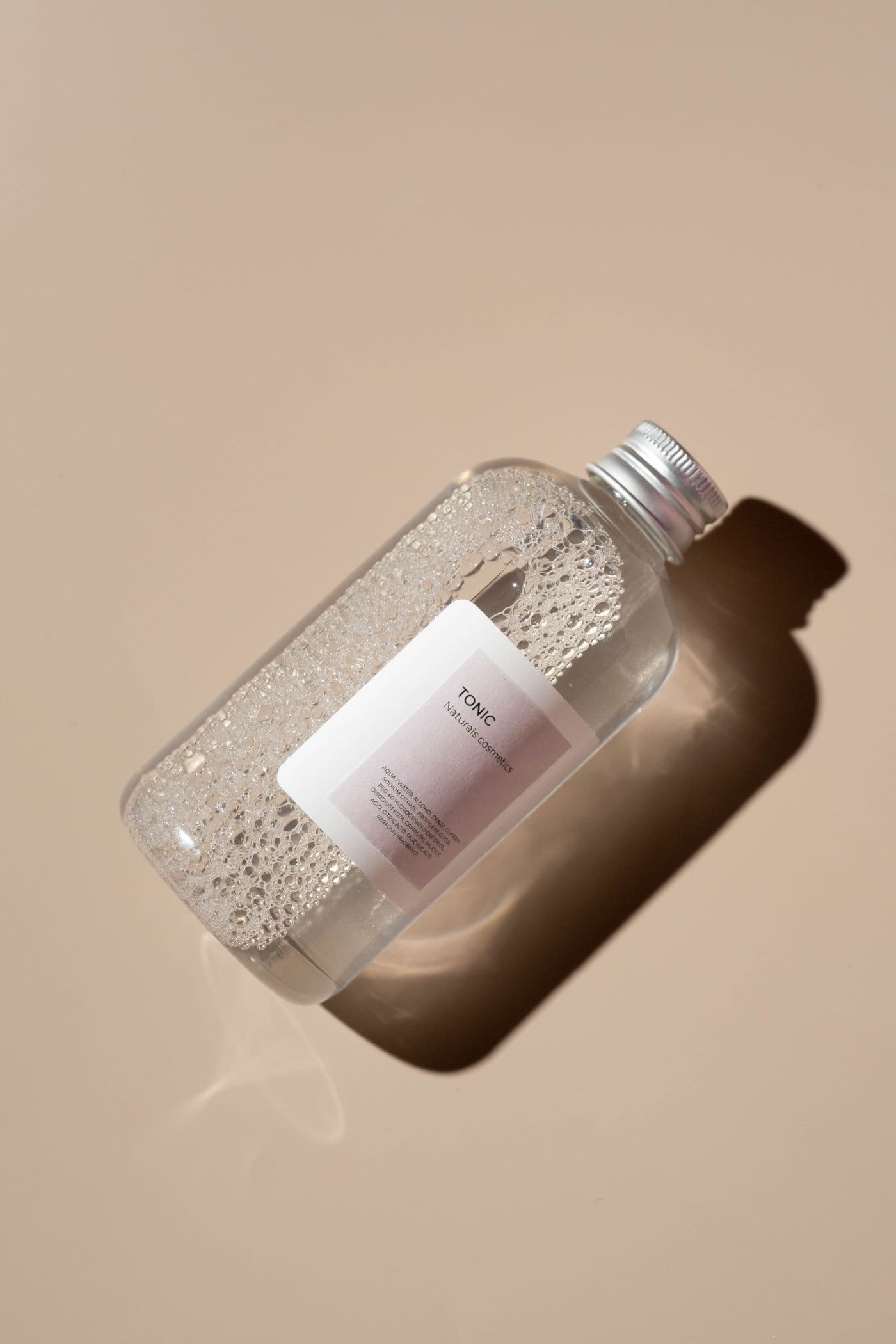A clear toner bottle with a visible ingredient label
